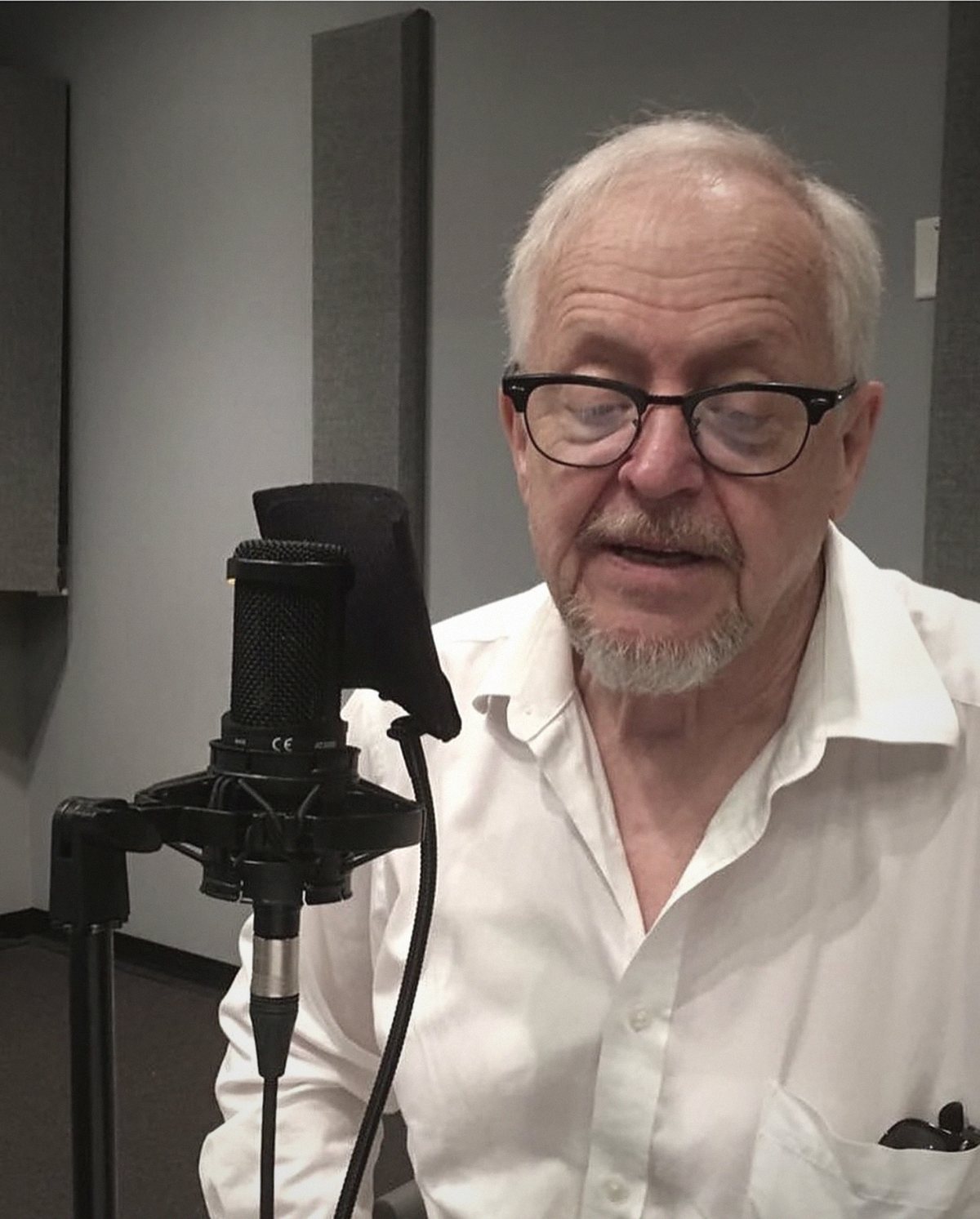 Eric Peterson at the microphone, recording an episode of PlayME.